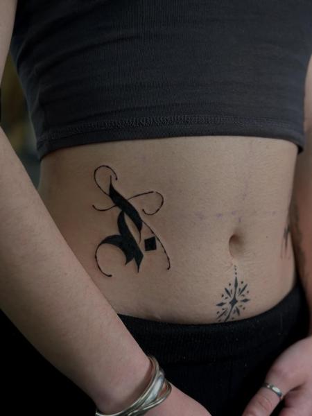 Blackwork ornamental letter tattoo by @sofinatattoo