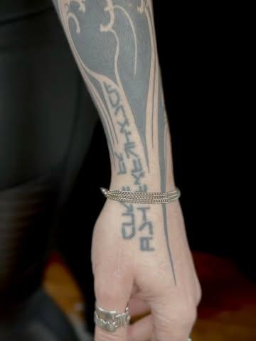 Tribal tribal script tattoo by @stewart_modernclassic