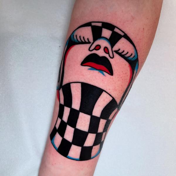 Illustrative checkered face tattoo by @stoyjunx