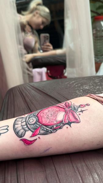 Color rose perfume bottle tattoo by @sue_tattoos