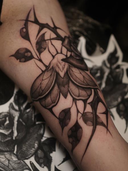 Blackwork moth and thorns tattoo by @sylvia__ink