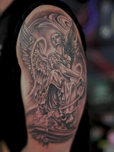 Realism angel statue tattoo by @tattooinestudios
