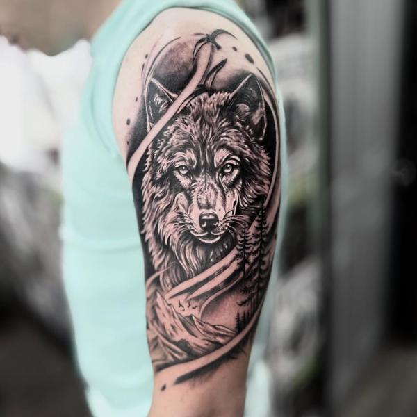 Realism wolf landscape tattoo by @tattooinestudios