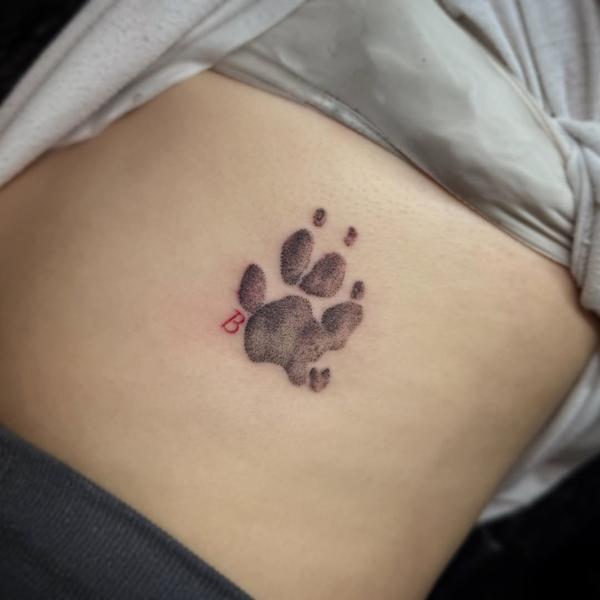 Dotwork paw print tattoo by @tattoosbycay