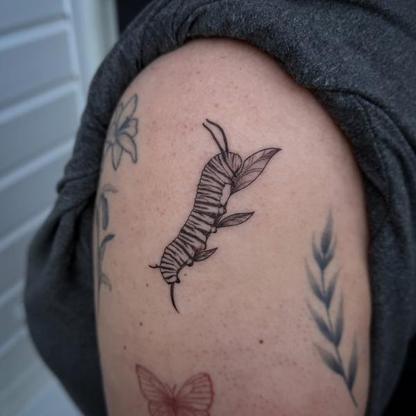 Fine line striped caterpillar tattoo by @tattoosbycay