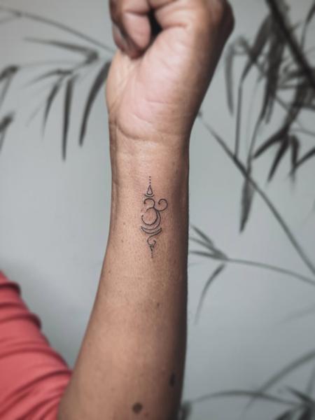 Fine line ornamental om tattoo by @terrie_titouutattoo