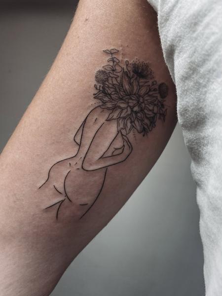 Fine line floral nude tattoo by @terrie_titouutattoo