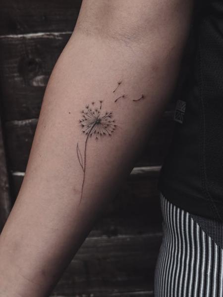 Fine line blowing dandelion tattoo by @terrie_titouutattoo