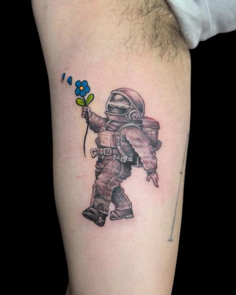 Illustrative astronaut with flower tattoo by @the_dan_gold