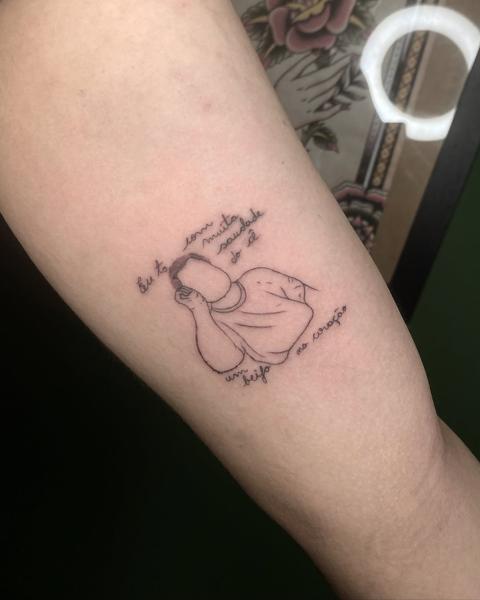 Fine line sleeping figure with text tattoo by @titotattooart_