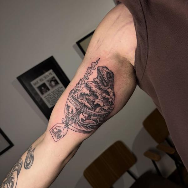 Illustrative blackwork frog in bowl tattoo by @titotattooart_