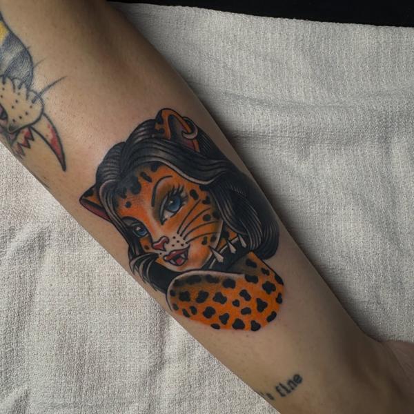Neo-traditional pin-up leopard tattoo by @titotattooart_