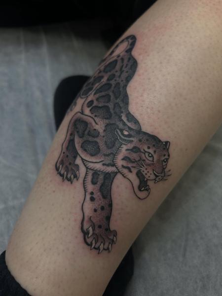 Traditional crouching leopard tattoo by @trav.tatts