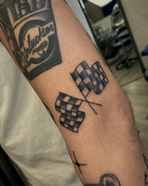 Traditional checkered flags tattoo by @usual_suspect_ttt