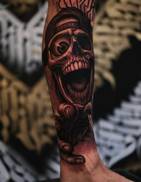 Realism laughing skull cap tattoo by @inkbyroer