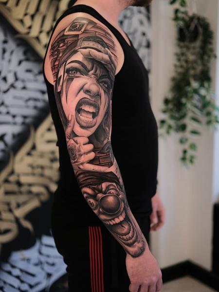 Realism screaming woman clown tattoo by @inkbyroer