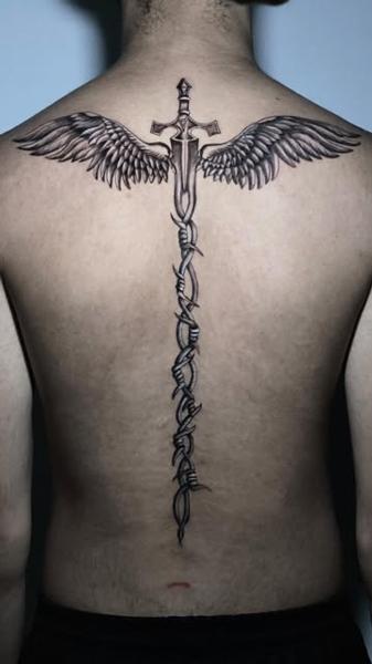 Illustrative winged sword barbed wire tattoo by @wagnervibes_tattoo