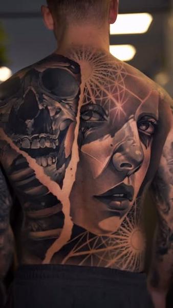 Realism split face skull tattoo by @wilkendorftattoo