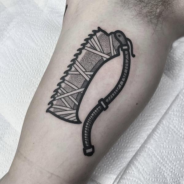 Blackwork abstract scythe tattoo by @anshin_anshin_tattoo