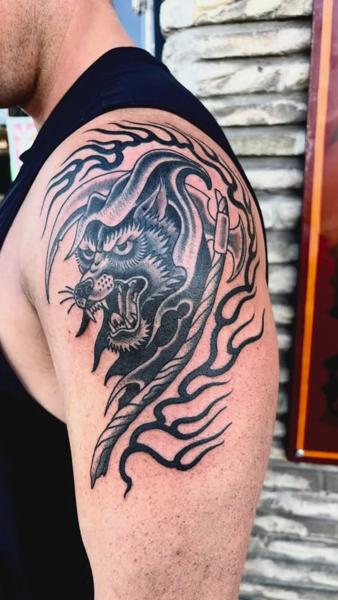 Traditional wolf and flames tattoo by @wolfslayertattoos