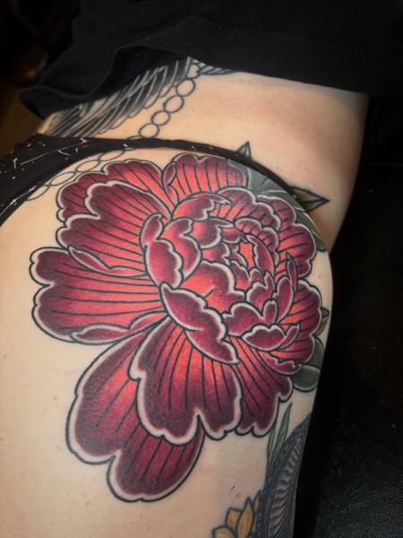 Traditional red flower tattoo by @wolfslayertattoos