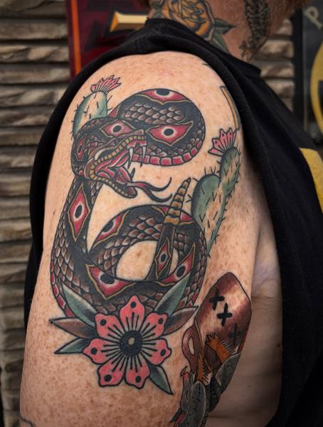 Traditional snake and flower tattoo by @wolfslayertattoos