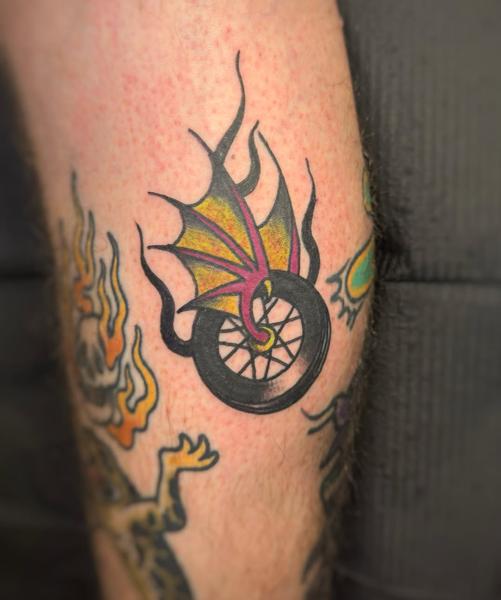 Traditional dragon wheel tattoo by @elpincheloco