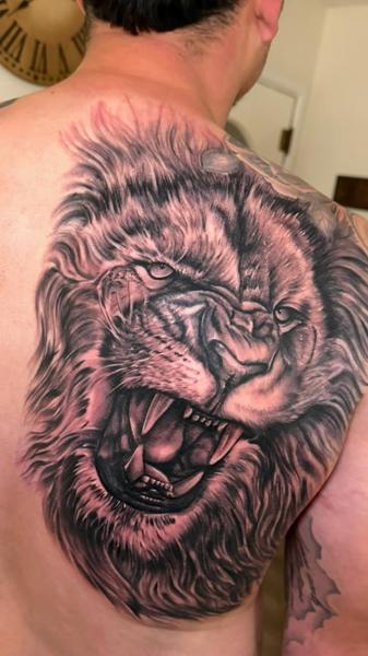 Realism roaring lion tattoo by @zamor_art