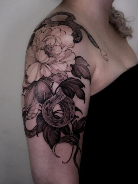 Blackwork floral snake tattoo by @zozutattoo