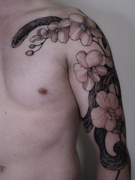 Blackwork floral snake tattoo by @zozutattoo