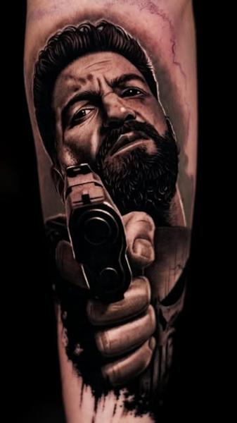 Realism punisher portrait gun tattoo by @zuzaink